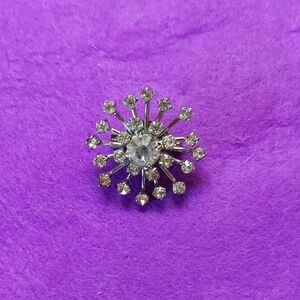 Silver Starburst Brooch with Sparkling Gemstones